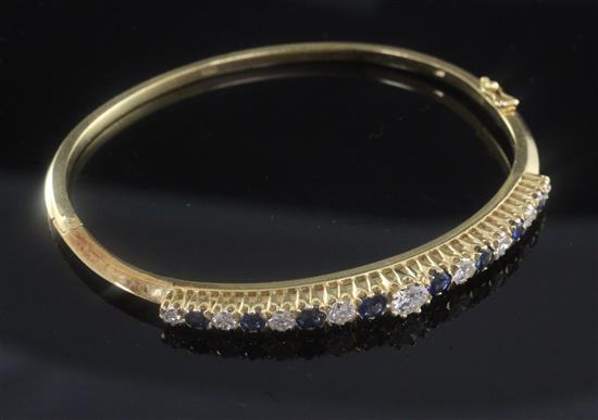 A modern 18ct gold, diamond and sapphire hinged bangle,